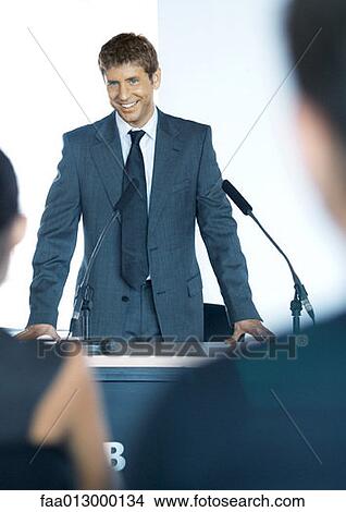 Speaker standing next to microphones during seminar View Large Photo Image Picture - Speaker standing next to microphones during seminar. Fotosearch