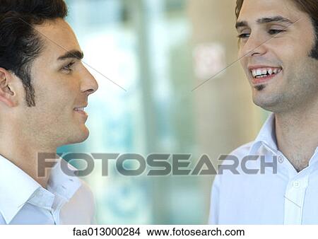 Two young make executives talking View Large Photo Image Picture - Two young make executives talking. Fotosearch