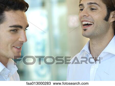 Stock Image - Two young male executives laughing. Fotosearch