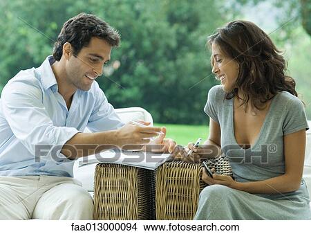 Woman and man working, outdoors in armchairs View Large Photo Image Picture - Woman and man working, outdoors in armchairs. Fotosearch