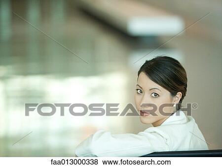 Woman, looking over shoulder at camera View Large Photo Image Stock Photo - Woman, looking over shoulder at camera. Fotosearch