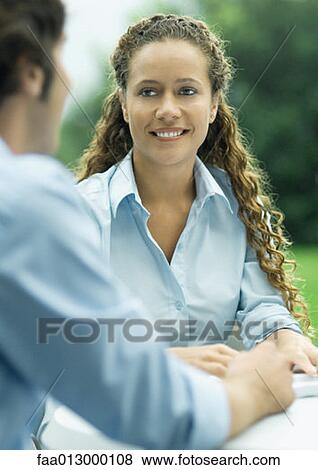 Woman smiling at man View Large Photo Image Stock Photo - Woman smiling at man. Fotosearch