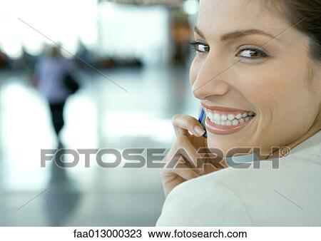 Woman using cell phone in airport View Large Photo Image Stock Image - Woman using cell phone in airport. Fotosearch