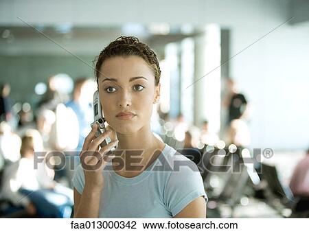 Woman using cell phone in airport View Large Photo Image Stock Image - Woman using cell phone in airport. Fotosearch