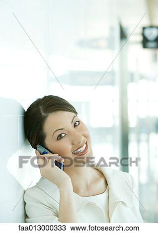 Stock Image - Woman using cell phone. Fotosearch