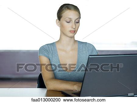 Young businesswoman using laptop View Large Photo Image Stock Image - Young businesswoman using laptop. Fotosearch