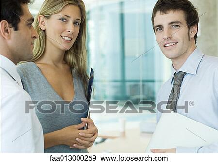 Young executives, smiling at camera View Large Photo Image Stock Photo - Young executives, smiling at camera. Fotosearch