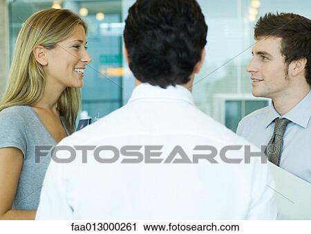Young executives talking View Large Photo Image Stock Image - Young executives talking. Fotosearch
