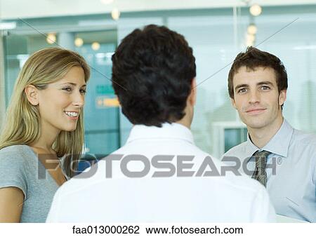 Young executives talking View Large Photo Image Stock Image - Young executives talking. Fotosearch
