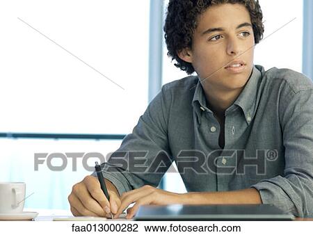 Young office worker taking notes View Large Photo Image Stock Image - Young office worker taking notes. Fotosearch
