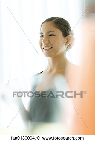 Young woman smiling, blur in foreground View Large Photo Image Stock Image - Young woman smiling, blur in foreground. Fotosearch