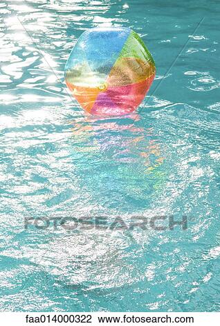 Beach ball floating on surface of water View Large Photo Image Stock Image - Beach ball floating on surface of water. Fotosearch