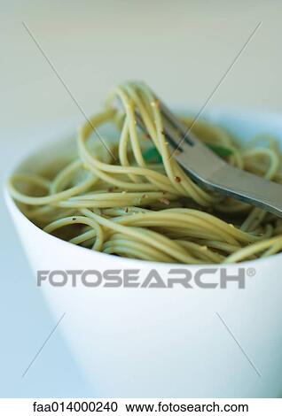Bowl of pesto pasta and fork View Large Photo Image Stock Image - Bowl of pesto pasta and fork. Fotosearch