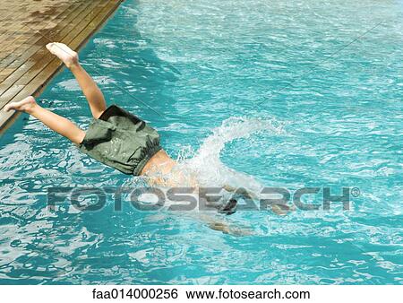 Stock Photograph - Boy diving into pool. Fotosearch