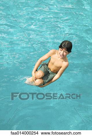 Boy jumping into pool View Large Photo Image Picture - Boy jumping into pool. Fotosearch