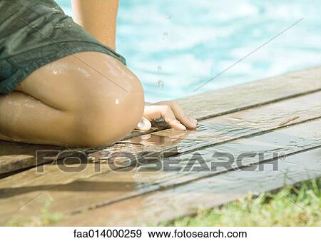 Boy sitting by edge of pool, close-up of knee View Large Photo Image Stock Photo - Boy sitting by edge of pool, close-up of knee. Fotosearch