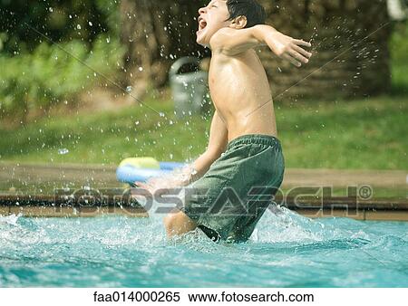 Boy splashing in swimming pool View Large Photo Image Stock Photography - Boy splashing in swimming pool. Fotosearch