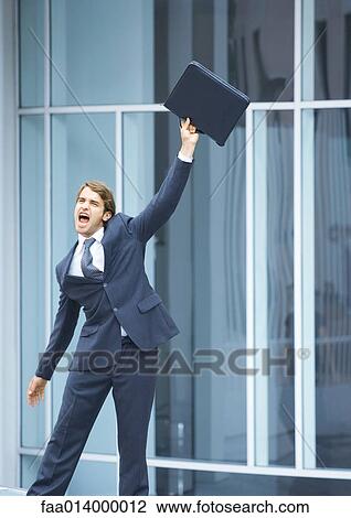 Businessman swinging briefcase and shouting View Large Photo Image Stock Image - Businessman swinging briefcase and shouting. Fotosearch