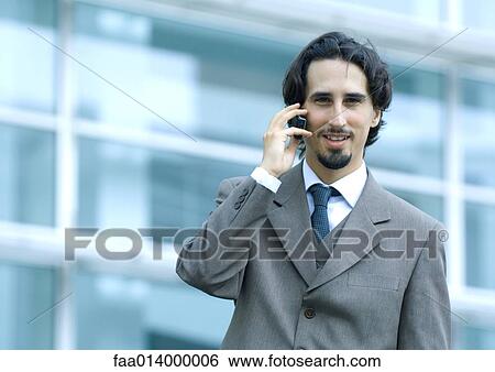 Businessman using cell phone, portrait View Large Photo Image Stock Photograph - Businessman using cell phone, portrait. Fotosearch