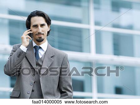 Businessman using cell phone, portrait View Large Photo Image Stock Photography - Businessman using cell phone, portrait. Fotosearch