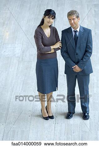 Businesswoman and businessman standing side by side, smiling at camera, portrait View Large Photo Image Stock Photo - Businesswoman and businessman standing side by side, smiling at camera, portrait. Fotosearch