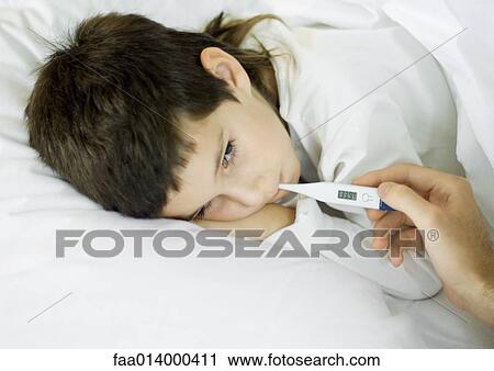 Child lying in bed, having temperature taken View Large Photo Image Stock Image - Child lying in bed, having temperature taken. Fotosearch