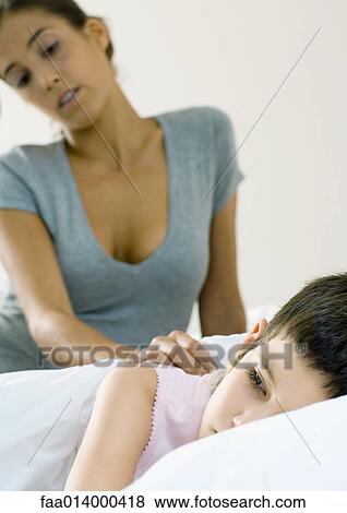 Child lying in bed, mother watching View Large Photo Image Stock Photo - Child lying in bed, mother watching. Fotosearch