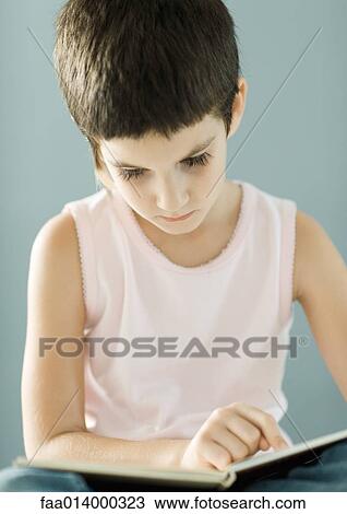 Stock Image - Child reading book. Fotosearch