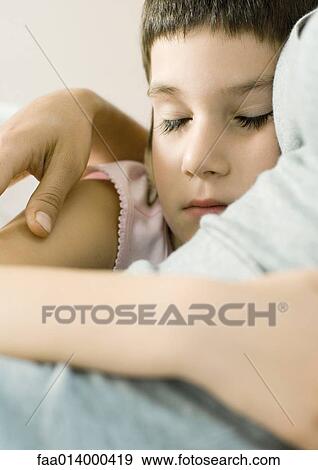 Child sleeping with arm around mother View Large Photo Image Stock Photo - Child sleeping with arm around mother. Fotosearch
