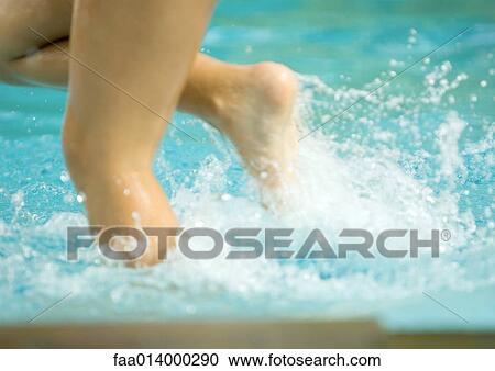 Child splashing in pool water, close-up of legs View Large Photo Image Stock Image - Child splashing in pool water, close-up of legs. Fotosearch