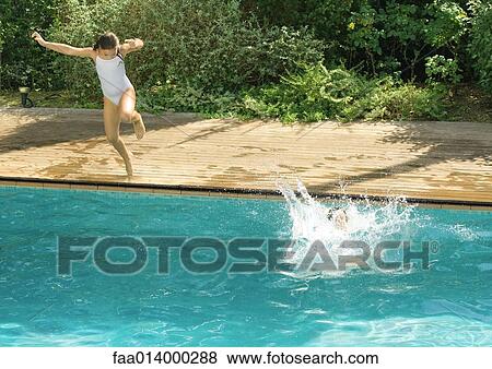 Children jumping into swimming pool View Large Photo Image Stock Photo - Children jumping into swimming pool. Fotosearch