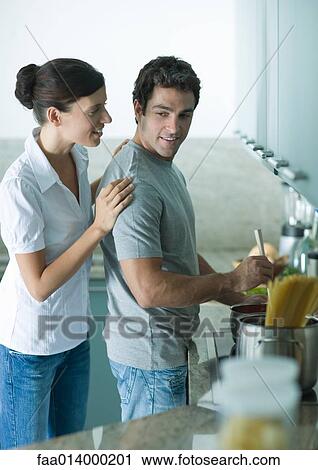 Couple cooking in kitchen together View Large Photo Image Stock Image - Couple cooking in kitchen together. Fotosearch