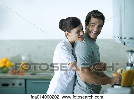 Couple cooking in kitchen together View Large Photo Image Stock Image - Couple cooking in kitchen together. Fotosearch