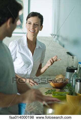 Stock Photo - Couple cooking in kitchen together. Fotosearch