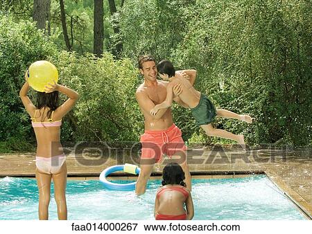 Father and children playing in swimming pool View Large Photo Image Stock Photo - Father and children playing in swimming pool. Fotosearch