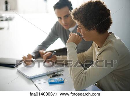 Father helping teenage son with homework View Large Photo Image Stock Photo - Father helping teenage son with homework. Fotosearch