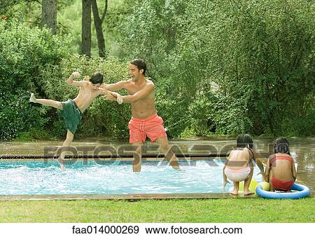 Father throwing son in swimming pool View Large Photo Image Stock Photo - Father throwing son in swimming pool. Fotosearch