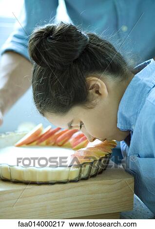 Girl and father making apple pie, girl lowering head to smell apples View Large Photo Image Stock Photo - Girl and father making apple pie, girl lowering head to smell apples. Fotosearch