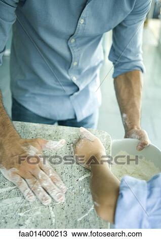 Girl and father wiping flour on counter into mixing bowl, cropped view View Large Photo Image Stock Image - Girl and father wiping flour on counter into mixing bowl, cropped view. Fotosearch