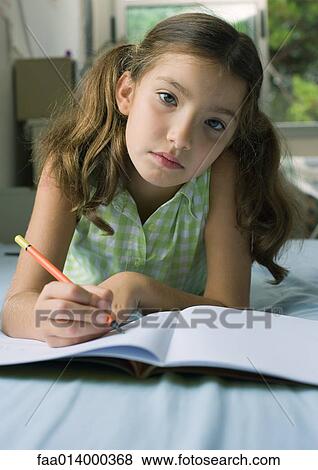 Girl doing homework View Large Photo Image Stock Photo - Girl doing homework. Fotosearch