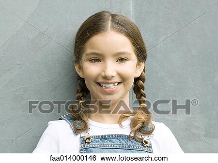 Girl leaning against wall and smiling, head and shoulders, portrait View Large Photo Image Stock Photograph - Girl leaning against wall and smiling, head and shoulders, portrait. Fotosearch