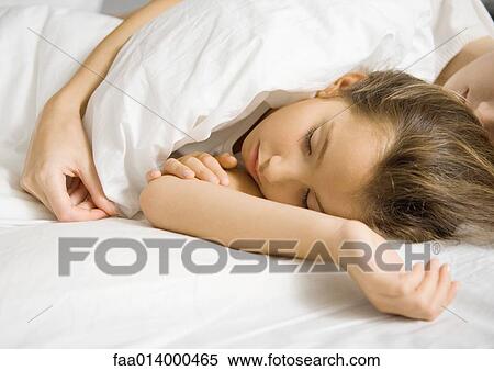 Girl lying in bed with mother's arm around her View Large Photo Image Stock Photography - Girl lying in bed with mother's arm around her. Fotosearch
