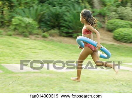 Girl running with ring around waist View Large Photo Image Stock Photo - Girl running with ring around waist. Fotosearch
