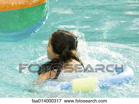 Girl using floating ring in pool View Large Photo Image Stock Photo - Girl using floating ring in pool. Fotosearch