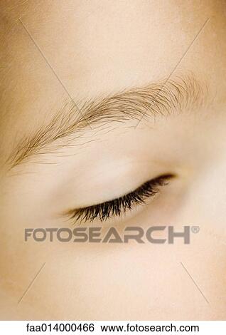 Stock Photograph - Girl's closed eye, extreme close-up. Fotosearch