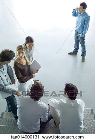 Stock Image - Group of colleagues talking. Fotosearch