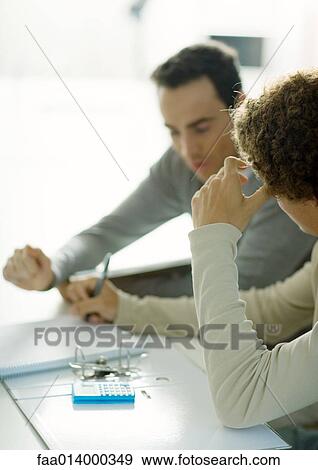 Man helping teenage son with homework View Large Photo Image Stock Photo - Man helping teenage son with homework. Fotosearch