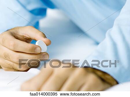 Man holding medicine, close-up of hands View Large Photo Image Stock Photography - Man holding medicine, close-up of hands. Fotosearch