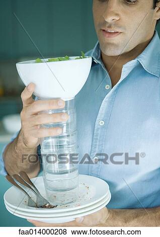 Man holding stack of dirty dishes View Large Photo Image Stock Photo - Man holding stack of dirty dishes. Fotosearch