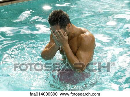 Man in pool wiping face View Large Photo Image Stock Image - Man in pool wiping face. Fotosearch